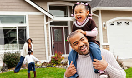 family in front of home